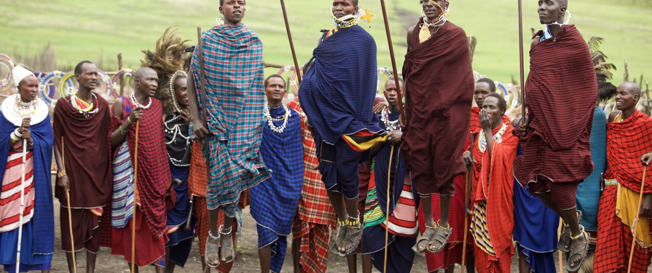 Maasai warriors performing a traditional jumping dance in northern Tanzania, celebrating cultural heritage and community traditions against the backdrop of the African savannah.