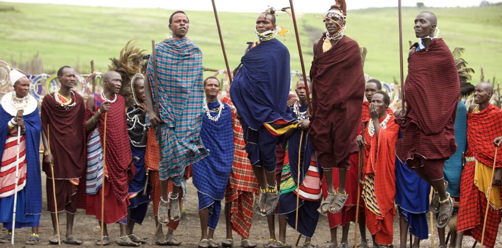 Maasai warriors performing a traditional jumping dance in northern Tanzania, celebrating cultural heritage and community traditions against the backdrop of the African savannah.
