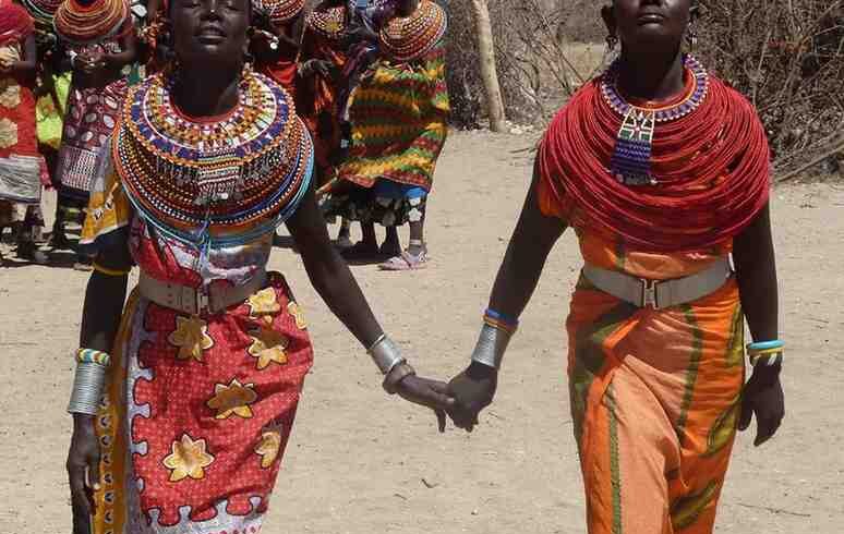 Young Maasai women in traditional attire during a cultural safari experience in Kenya