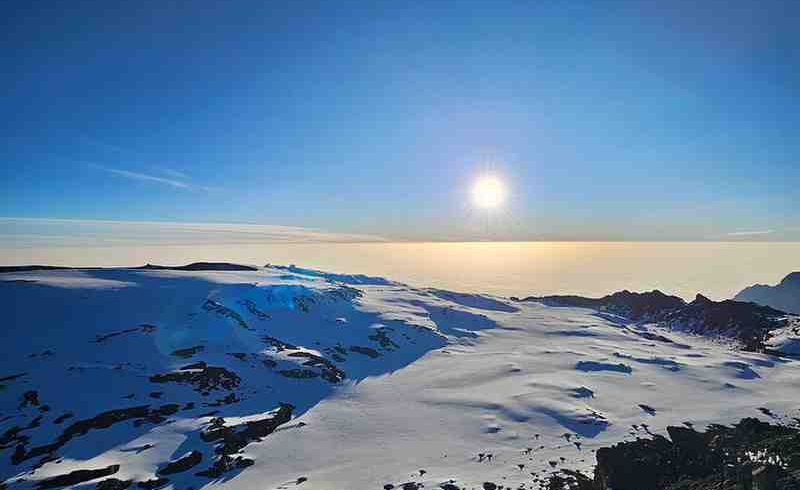 Panoramic view of Mount Kilimanjaro showcasing Tanzania's iconic trekking landscape with Ibhanilfa Safaris.