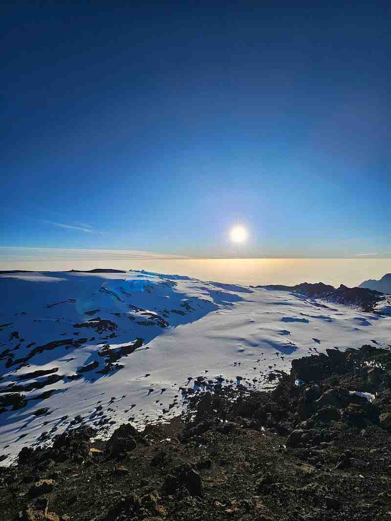 Panoramic view of Mount Kilimanjaro showcasing Tanzania's iconic trekking landscape with Ibhanilfa Safaris.