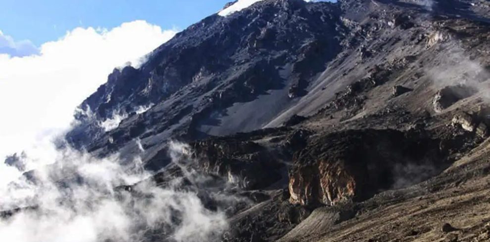 Scenic landscape of the Umbwe Route on Mount Kilimanjaro, Tanzania with steep forested mountain terrain.