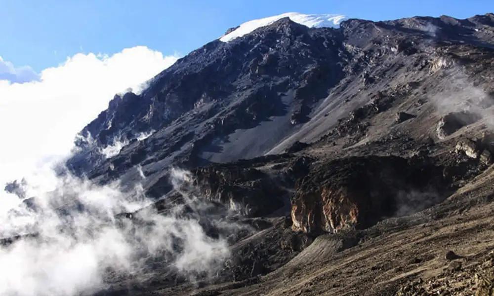 Scenic landscape of the Umbwe Route on Mount Kilimanjaro, Tanzania with steep forested mountain terrain.