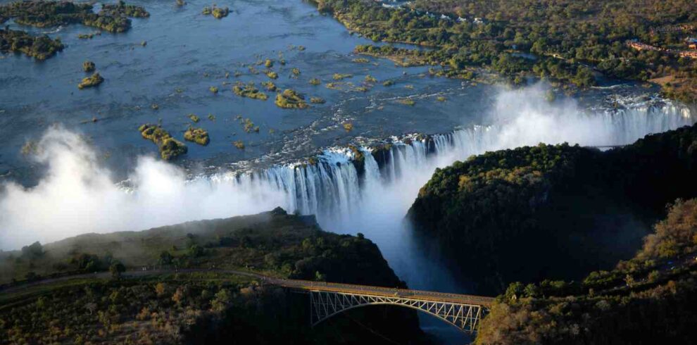 Victoria Falls experience featuring iconic waterfalls, Zambezi River landscapes, rainforest scenery, and adventure activities in Zimbabwe and Zambia